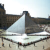 A group of people standing around the pyramid.