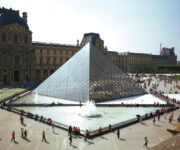 A group of people standing around the pyramid.