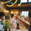 A group of people sitting at tables with wine glasses.