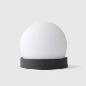 A white ball lamp sitting on top of a table.