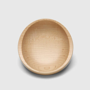 A wooden bowl with no lid on top of a white table.