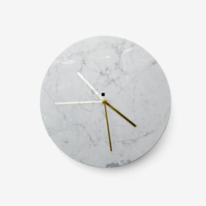 A clock with a marble face and gold hands.
