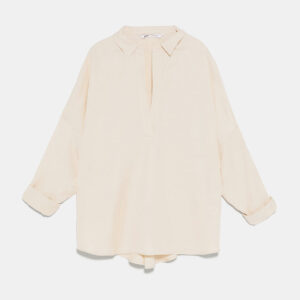 A white shirt with long sleeves and a tie.