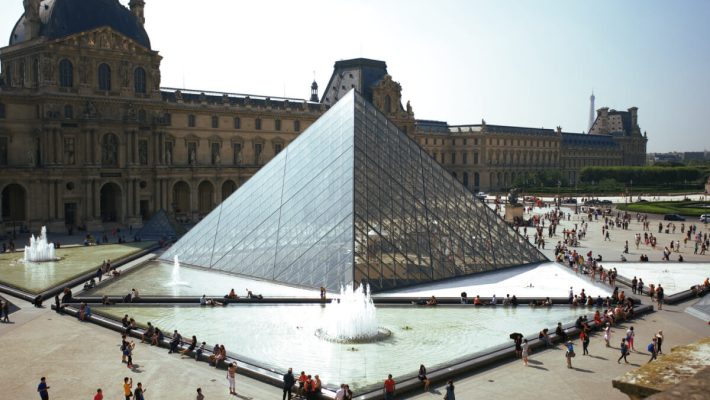 A group of people standing around the pyramid.